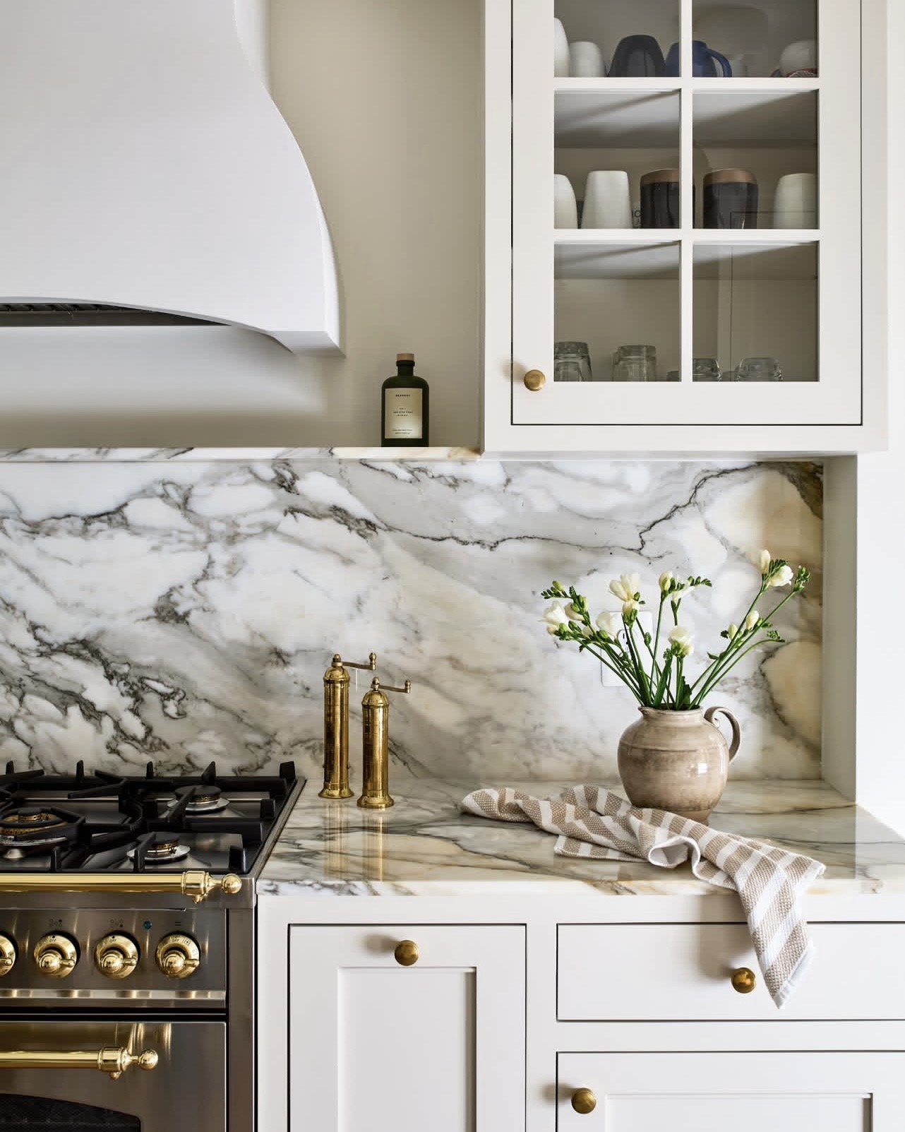 Finished luxury kitchen showcasing a range as the defining centerpiece of the space