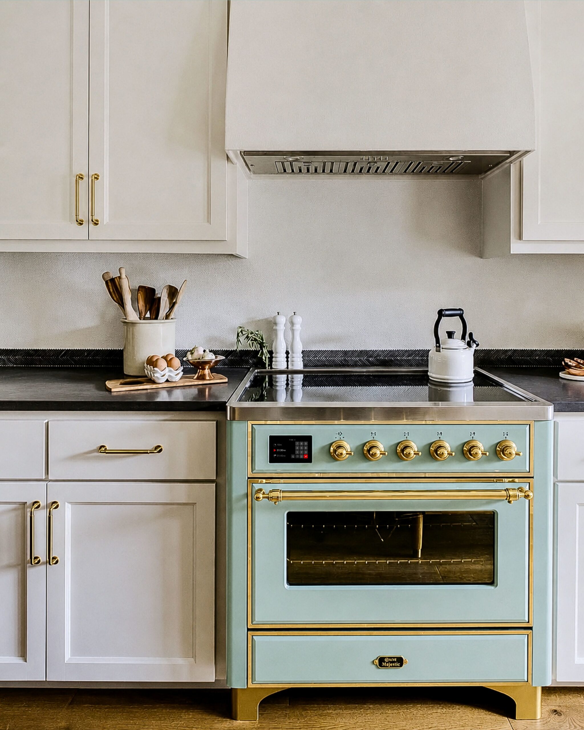 Mediterranean Mint ILVE Majestic range in a warm white luxury kitchen with ivory cabinetry